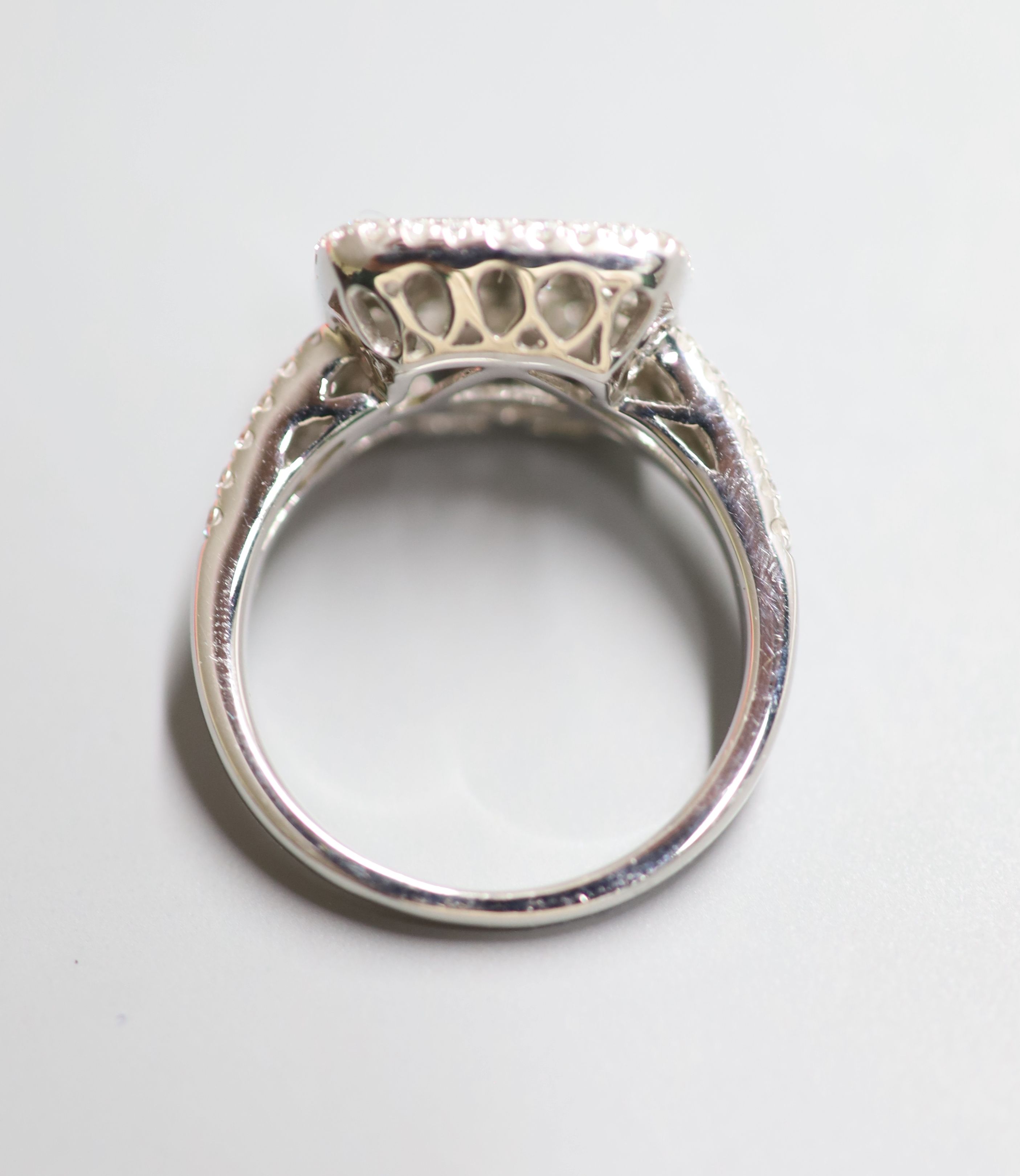 A modern 18ct white gold and diamond square cluster ring, with twin row diamond set shoulders, size Q, gross 6.8 grams,